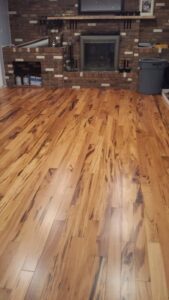 5 inch tigerwood hardwood flooring in living room family room with fireplace